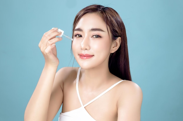 Asian woman with a beautiful face and Perfect clean fresh skin Cute female model with natural makeup and sparkling eyes on white isolated background Facial treatment Cosmetology beauty Concept