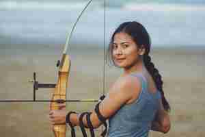 Photo asian woman with bow arachery