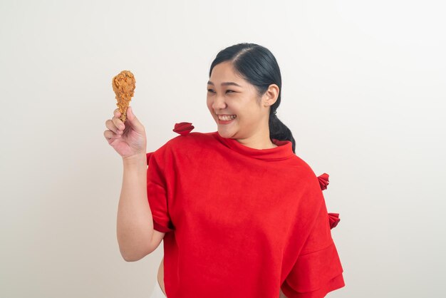 Asian woman with fried chicken on hand