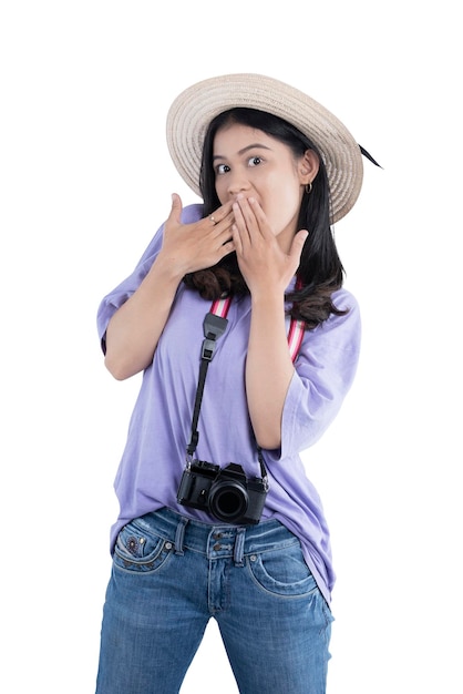 Asian woman with hat and camera standing with shocked expression isolated over white background