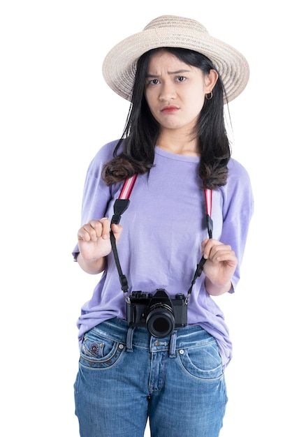 Asian woman with hat and camera standing with unhappy expression isolated over white background