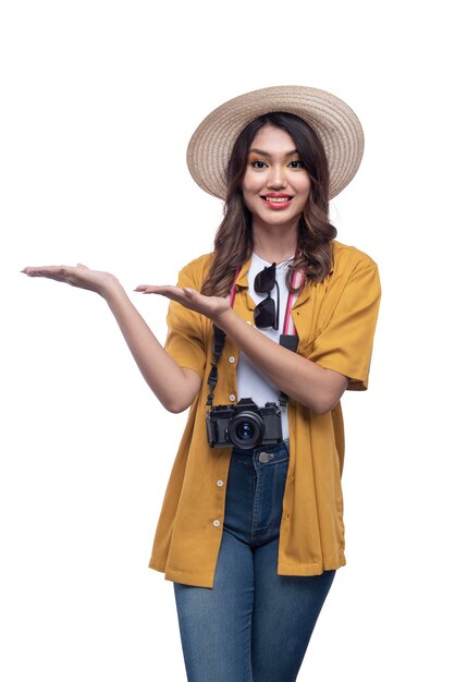 Asian woman with a hat and camera with open palm pointing at something