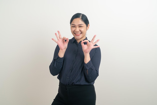 Asian woman with ok hand sign on white background