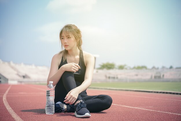 Asian woman with sport clothing exercise outdoor. 