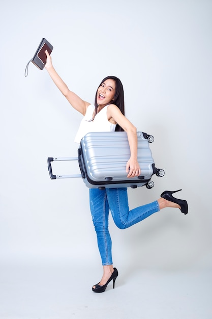 Asian woman with suitcase bright