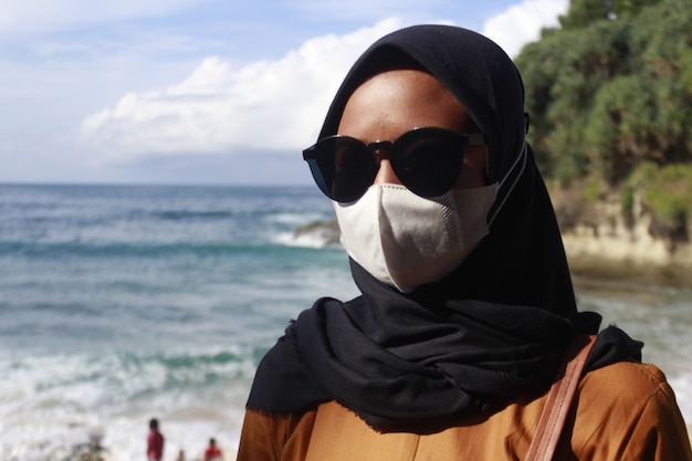 Asian woman with sunglasses on the beach