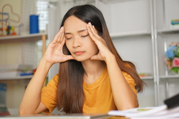 Asian woman working from home Tired of paperwork that is not completed on time