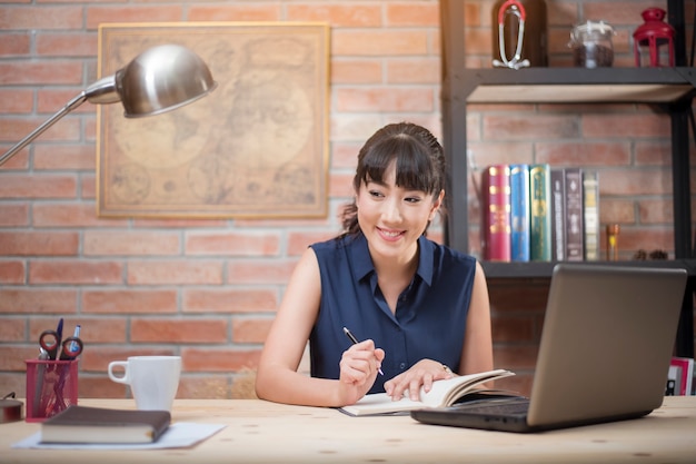 Asian woman working in her office