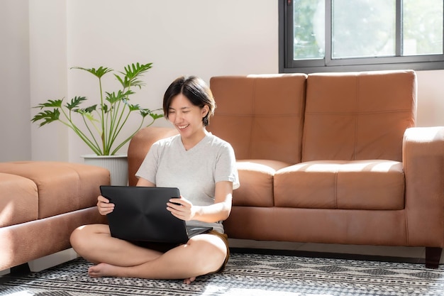 Asian woman working at home living room and happy smiling home\
living room atmosphere