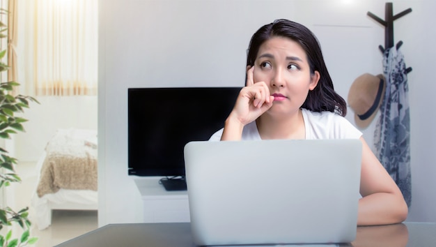 Asian woman working on the laptop at home