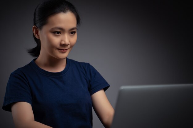 Asian woman working with laptop. Business woman working on laptop at office.