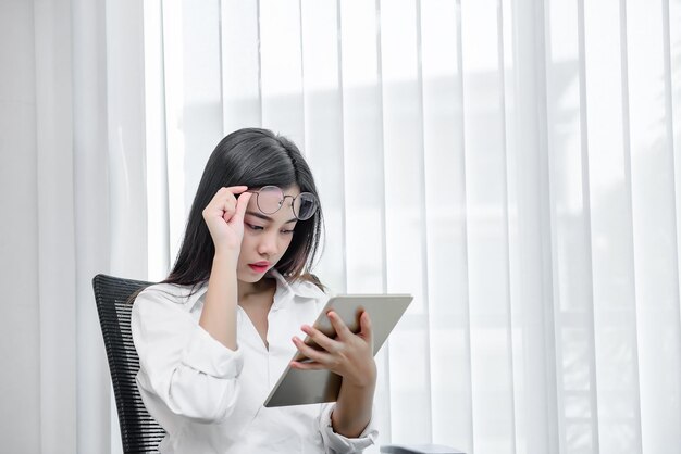 Asian woman working with tablet overtime in the officethailand people