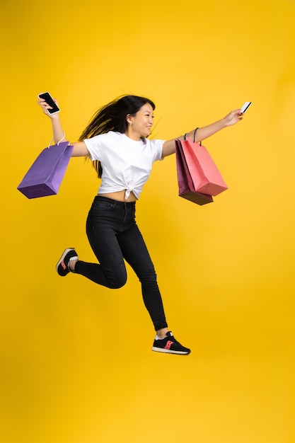 Asian woman on yellow background, emotions