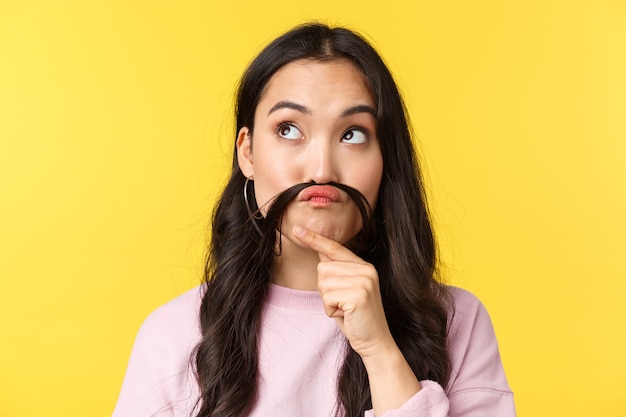 Asian woman on yellow background.