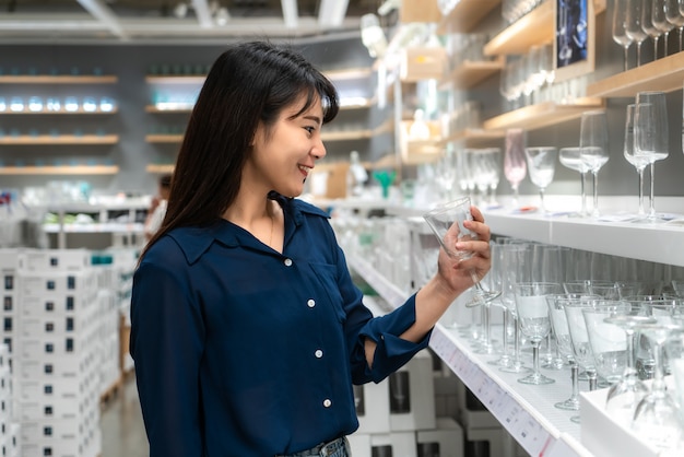 Asian women are choosing to buy new glass in the mall. Shopping for groceries and housewares.