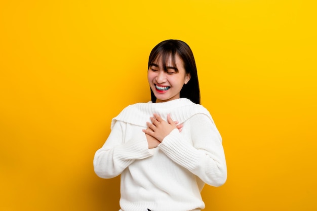 Asian women are cute young cute happy optimistic relaxed good physical health The photo was taken in a yellow backdrop studio