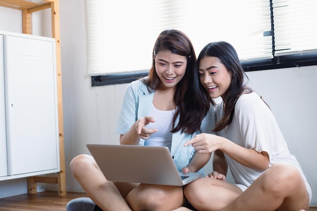 Asian women are excited about new technologies in shopping via laptop