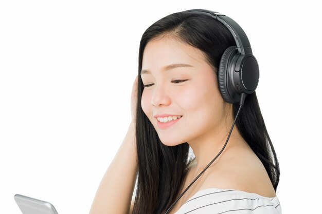 Asian Women are listening to music from black headphones