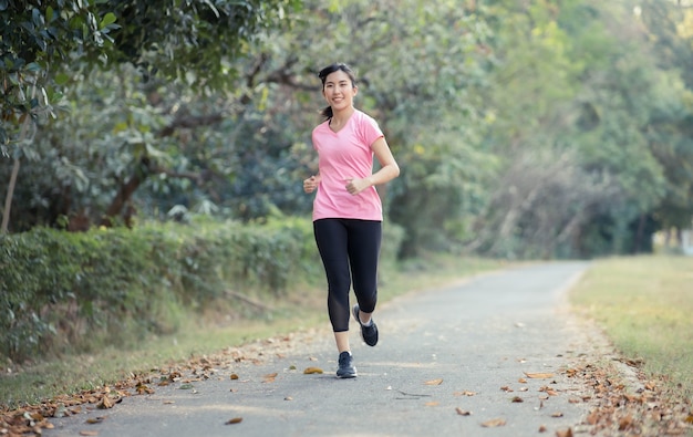 Asian women are running at the park to lose weight and stay healthy.