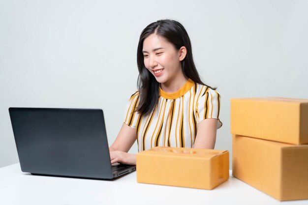 Asian women are starting a new business in the online market. Asian women checking products, preparing to deliver products to customers. SME Concept