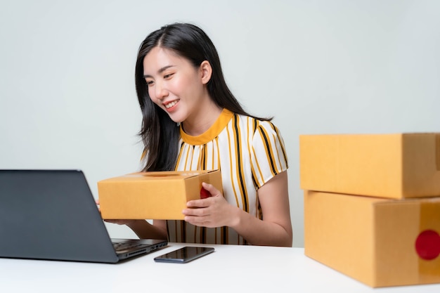 Asian women are starting a new business in the online market. Asian women checking products, preparing to deliver products to customers. SME Concept