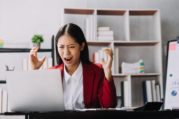 Asian women are stressed while working on laptop Tired asian businesswoman with headache at office feeling sick at work copy space