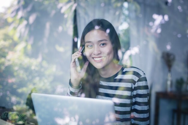 Asian women are using a telephone happily