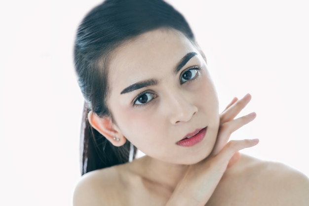 Asian women Beautiful with Clean Fresh Skin touch own face . Facial treatment . Cosmetology , beauty