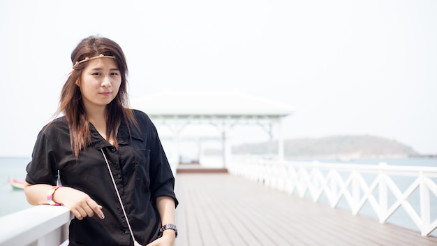 Asian women black shirt Standing wooden terrace