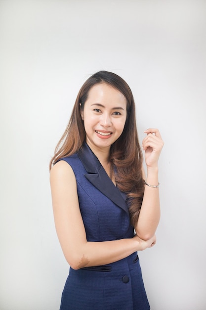 Asian women in blue dress with arms crossed and smile isolated