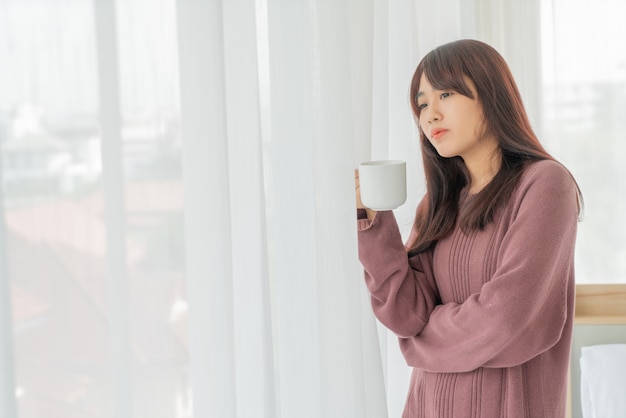 Asian women drinking coffee in the morning