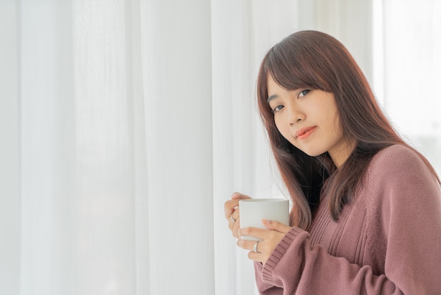 Asian women drinking coffee in the morning