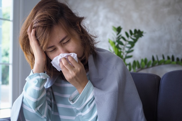 asian women have high fever and runny nose. sick people concept