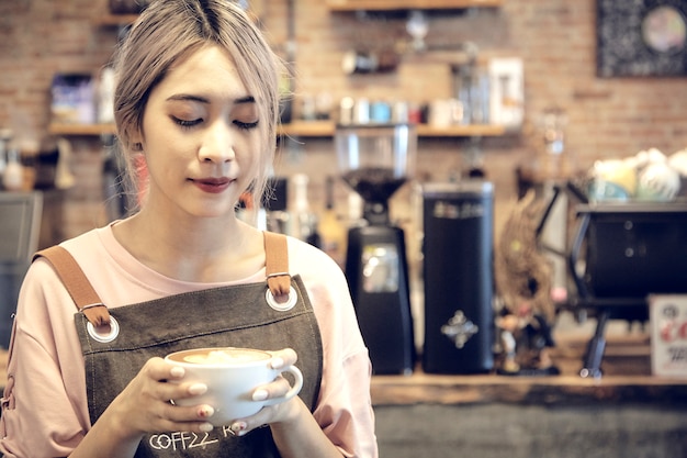 Asian Women Holding Coffee Cup  At Cafe