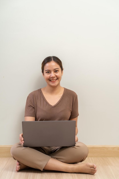ラップトップコンピューターを保持しているアジアの女性在宅ビジネスの概念から仕事