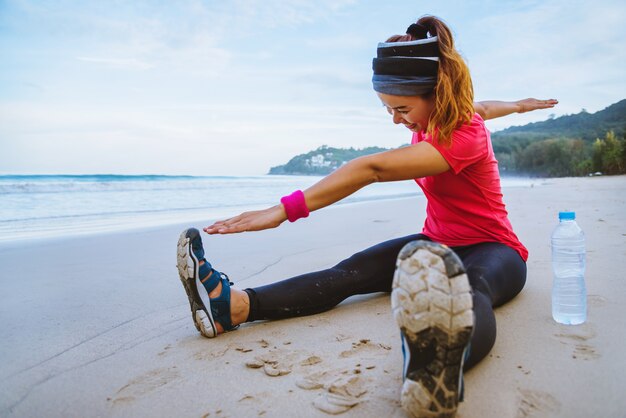 Asian women jogging workout on the beach.