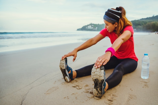 Asian women jogging workout on the beach.