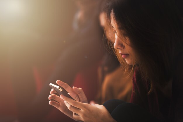 Asian women play phone 