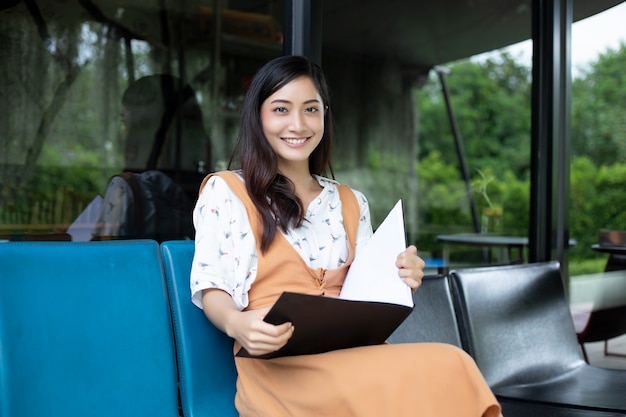 Asian women reading and smiling and happy Relaxing in a coffee shop 