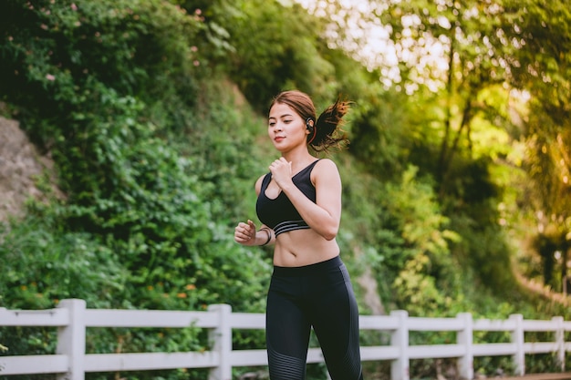 Asian women Running and jogging during outdoor on road in park