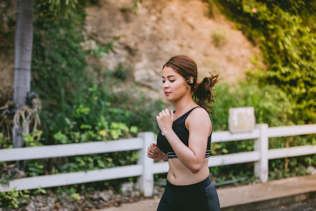 Asian women Running and jogging during outdoor on road in park