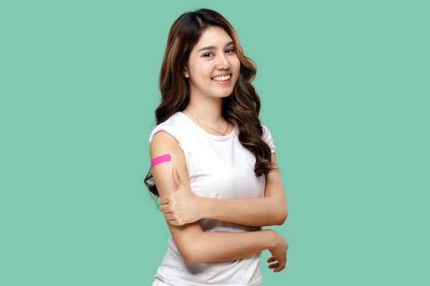 Asian Women Show Bandage On Arm Happy Asian Woman Feels Good After Received Vaccine Isolated On Green Background