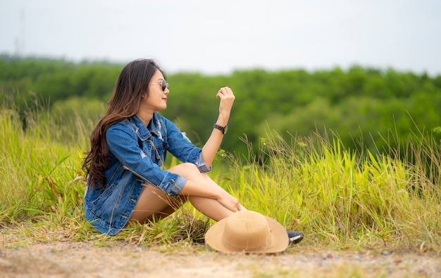 Asian women sitting in green meadow 