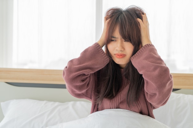 Asian women strain and serious on bed