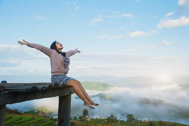 Asian women tourist sitting on balcony Morning sun does not hurt the skin.