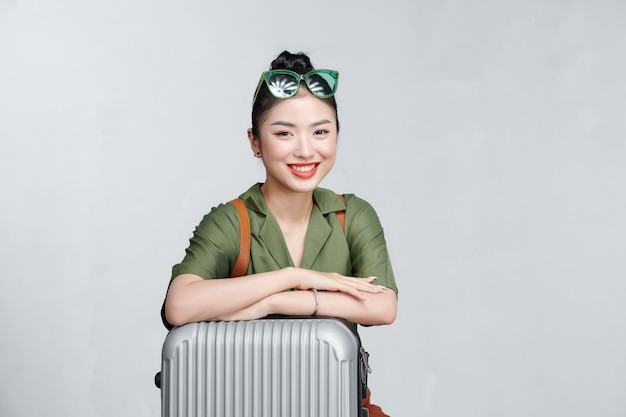 Asian women tourists she is sitting at the airport She uses a mobile phone