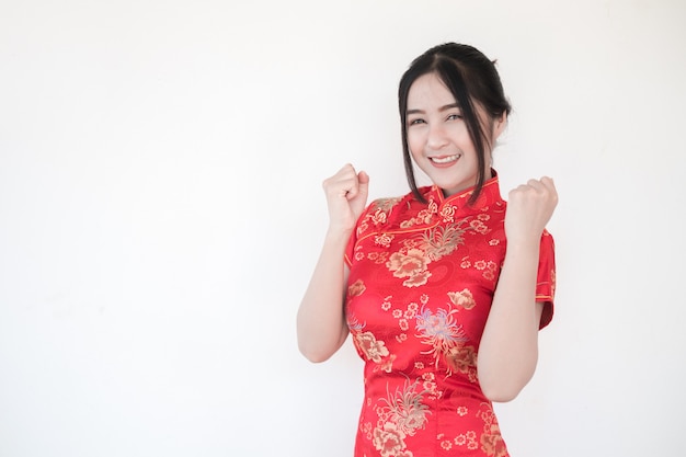 .Asian women in traditional Chinese cheongsam with a gesture of congratulations.