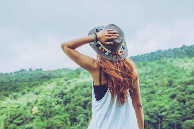 Asian women travel relax in the holiday. Wild nature wood on the mountain. 