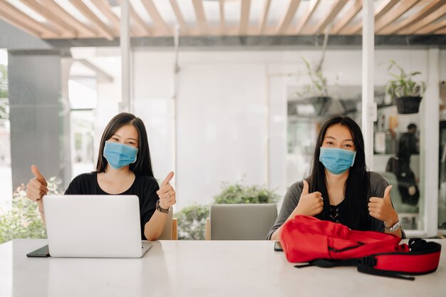 Asian women wearing face masks in the office