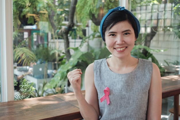 Asian women with pink ribbon, breast cancer awareness